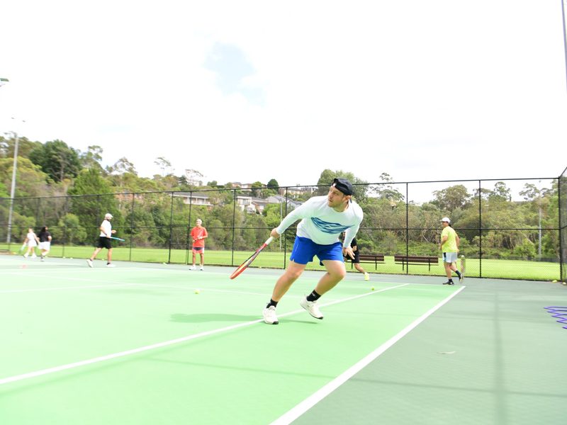 A player chasing down a forehand during the social afternoon